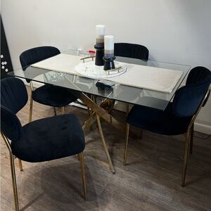 Elegant Glass Dining Table with Black and Gold Chairs